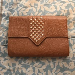 Tan clutch purse with rose gold studs